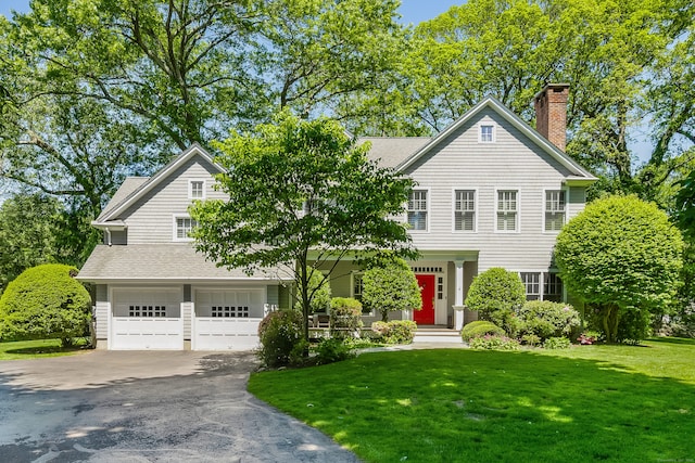 21 Park Pl, Darien, CT 06820 - view of front of property with driveway, a garage, a front yard, and a chimney