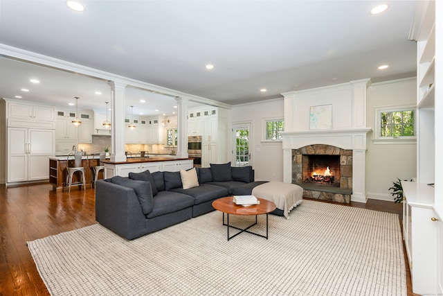 21 Park Pl, Darien, CT 06820 - living area featuring plenty of natural light, a stone fireplace, dark wood finished floors, recessed lighting, and ornamental molding
