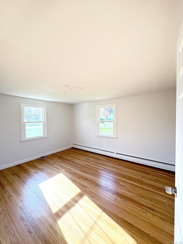 244 Spruce Brook Rd, Berlin, CT 06037 - empty room featuring healthy amount of natural light, a baseboard heating unit, wood finished floors, and baseboards