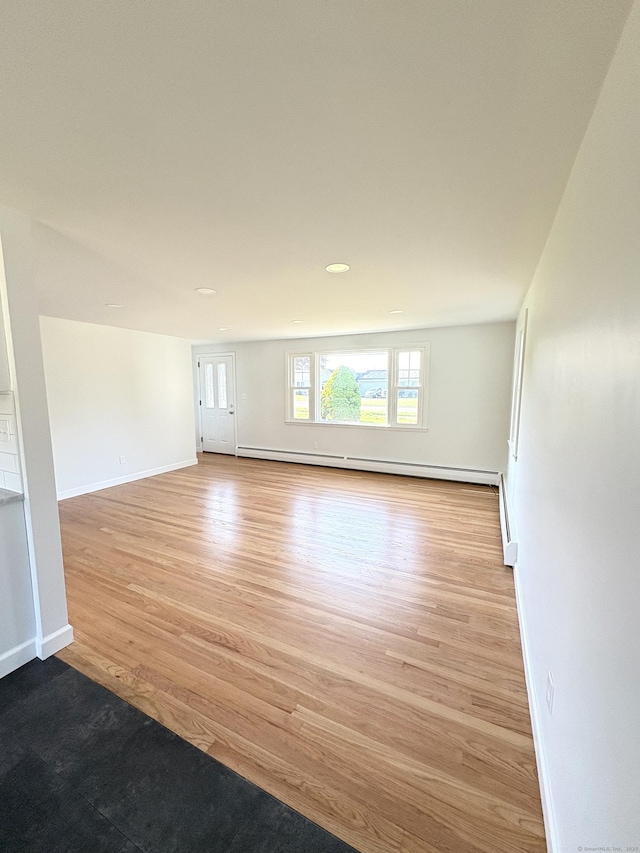 244 Spruce Brook Rd, Berlin, CT 06037 - empty room with light wood-type flooring, baseboards, and a baseboard radiator