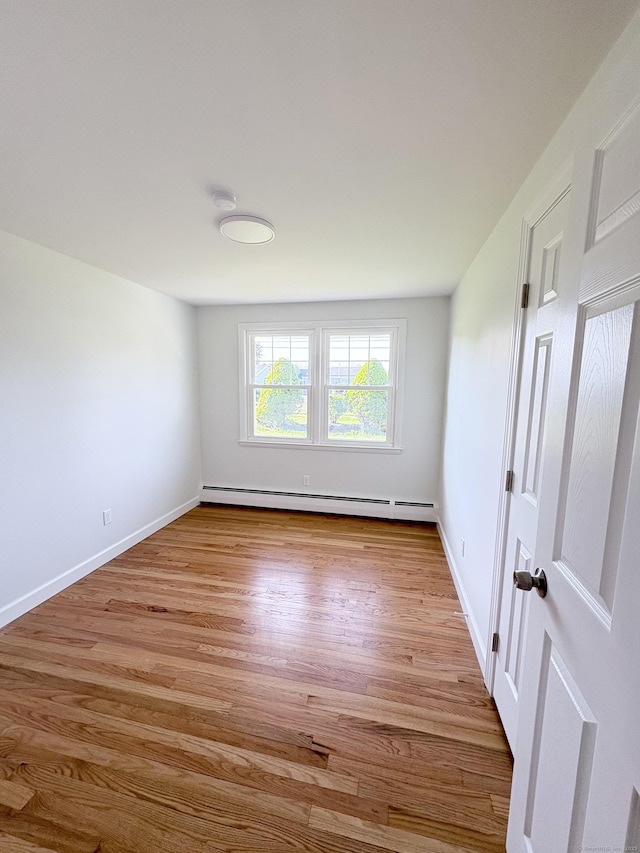 244 Spruce Brook Rd, Berlin, CT 06037 - unfurnished room featuring a baseboard heating unit, light wood-style floors, and baseboards