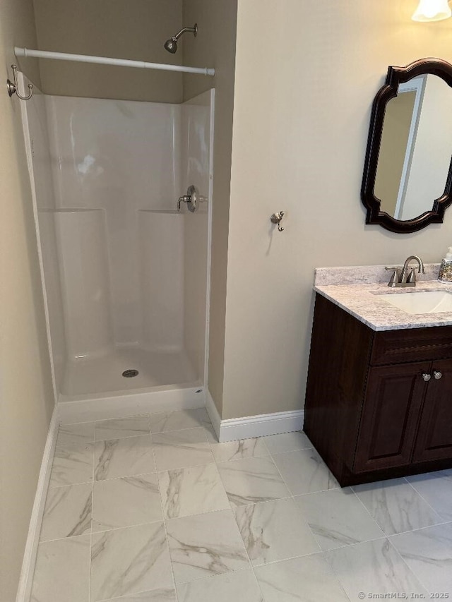 60 Pinehurst Dr Unit 60, East Haven, CT 06513 - bathroom with baseboards, marble look tiles, a shower, and vanity
