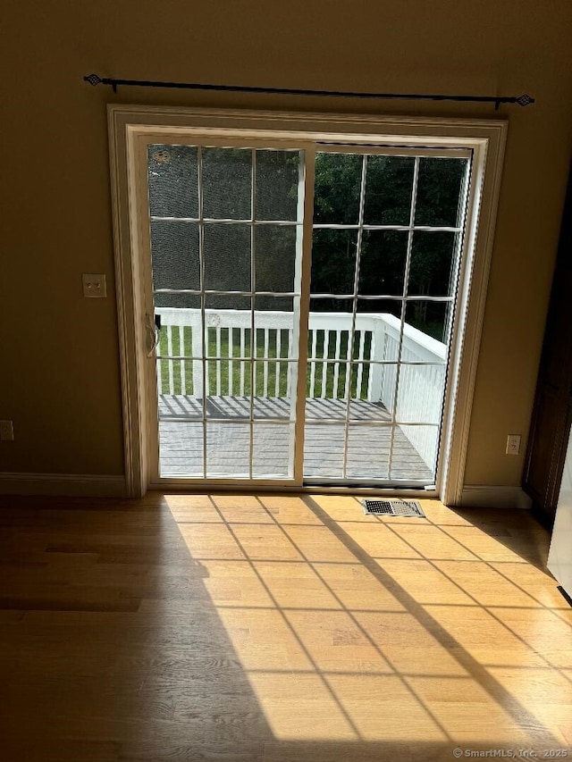 60 Pinehurst Dr Unit 60, East Haven, CT 06513 - doorway to outside featuring baseboards and wood finished floors