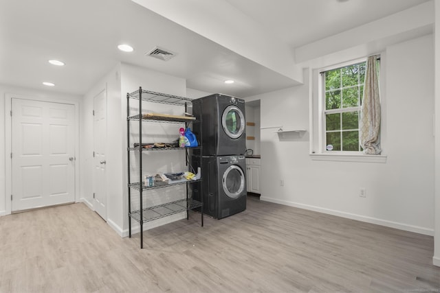 40 High Ridge Rd, Hamden, CT 06514 - clothes washing area featuring estacked washer and dryer, baseboards, wood finished floors, recessed lighting, and cabinet space
