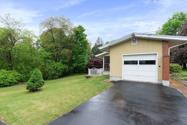 16 Ellsworth Rd, East Windsor, CT 06016 - view of front of home featuring a front lawn, asphalt driveway, a garage, and brick siding