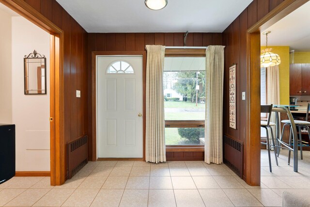 16 Ellsworth Rd, East Windsor, CT 06016 - entrance foyer featuring radiator, plenty of natural light, wooden walls, baseboards, and light tile patterned floors