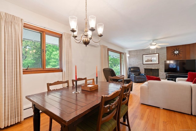 16 Ellsworth Rd, East Windsor, CT 06016 - dining area featuring a chandelier, a large fireplace, light wood finished floors, ceiling fan, and a baseboard radiator