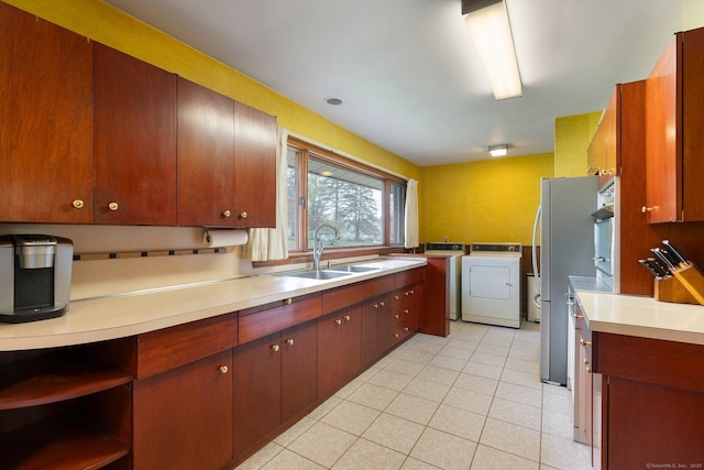 16 Ellsworth Rd, East Windsor, CT 06016 - kitchen featuring a sink, independent washer and dryer, wall oven, light tile patterned floors, and light countertops