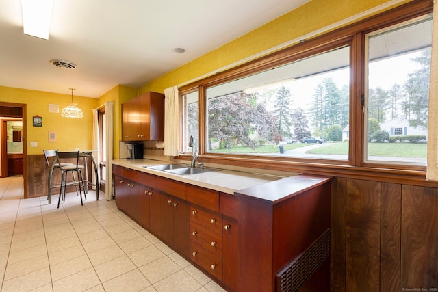 16 Ellsworth Rd, East Windsor, CT 06016 - kitchen featuring a sink, healthy amount of natural light, light tile patterned floors, and light countertops