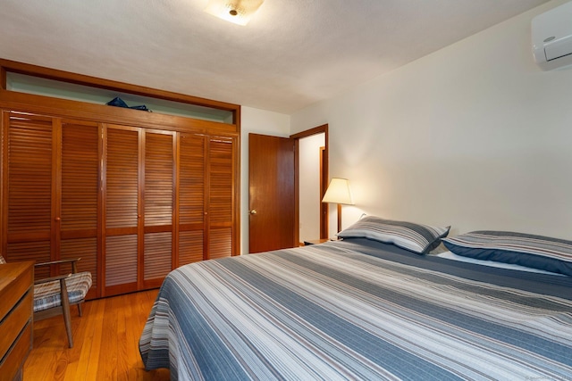 16 Ellsworth Rd, East Windsor, CT 06016 - bedroom featuring an AC wall unit, a closet, and light wood finished floors
