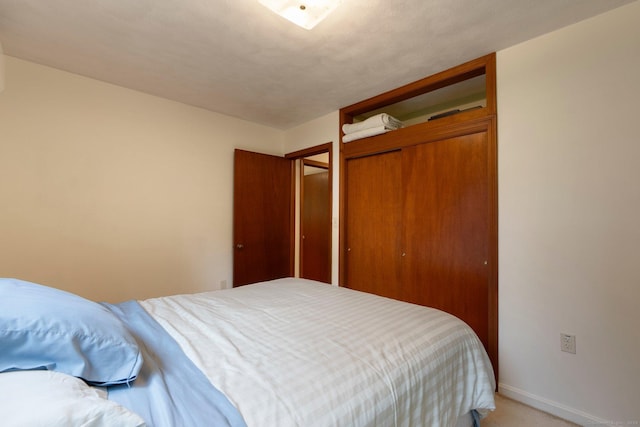 16 Ellsworth Rd, East Windsor, CT 06016 - bedroom featuring a closet, light colored carpet, and baseboards