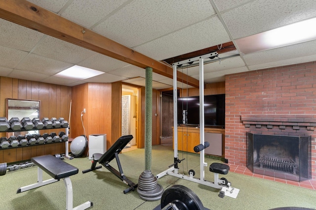 16 Ellsworth Rd, East Windsor, CT 06016 - exercise area with a drop ceiling, a brick fireplace, carpet flooring, and wooden walls