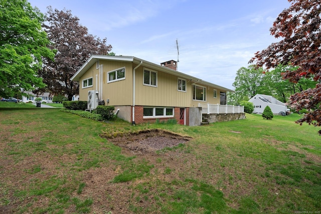16 Ellsworth Rd, East Windsor, CT 06016 - back of house featuring a yard and a chimney