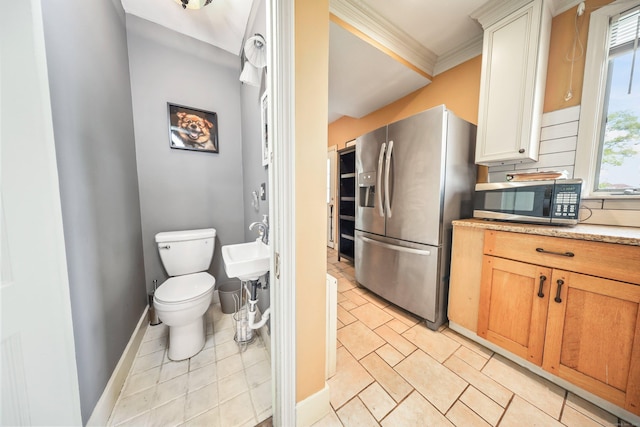 30 Birchwood St, Waterbury, CT 06708 - kitchen featuring appliances with stainless steel finishes, ornamental molding, and baseboards