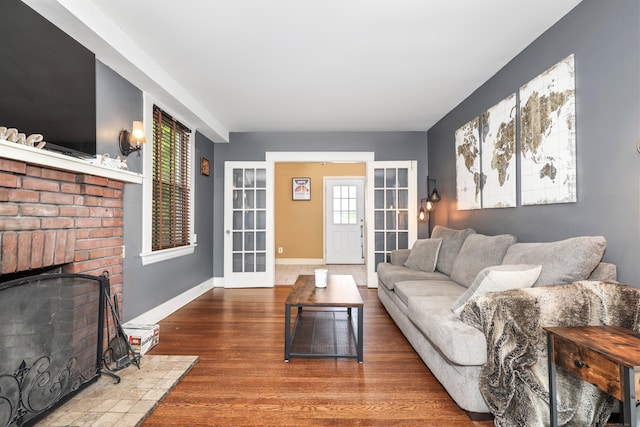30 Birchwood St, Waterbury, CT 06708 - living area featuring wood finished floors, french doors, a fireplace, and baseboards