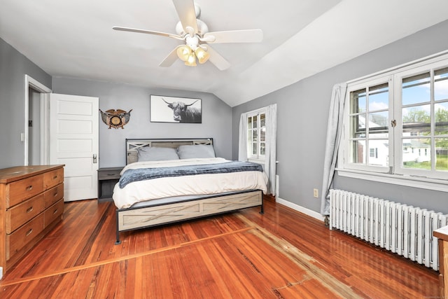 30 Birchwood St, Waterbury, CT 06708 - bedroom with radiator heating unit, wood finished floors, vaulted ceiling, baseboards, and ceiling fan