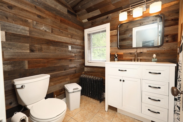 30 Birchwood St, Waterbury, CT 06708 - bathroom with radiator heating unit, wood walls, toilet, tile patterned flooring, and vanity