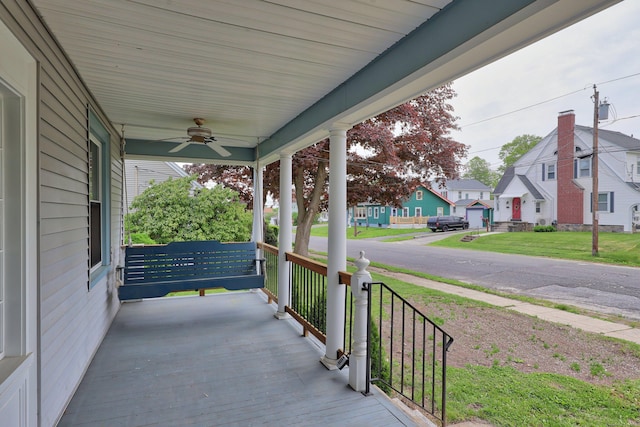30 Birchwood St, Waterbury, CT 06708 - wooden terrace with a porch, a ceiling fan, a residential view, and a lawn