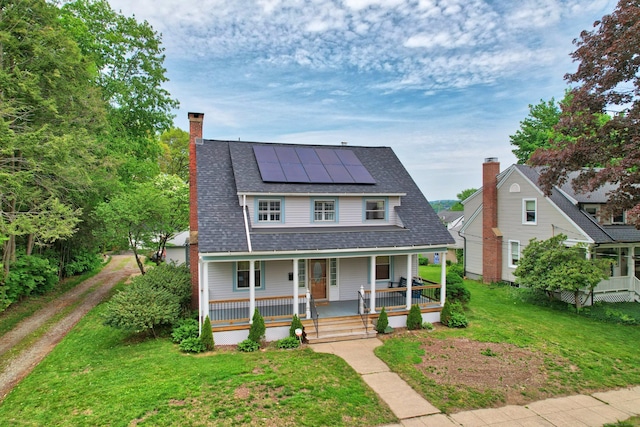 30 Birchwood St, Waterbury, CT 06708 - view of front of house featuring covered porch, a front lawn, roof mounted solar panels, and a chimney