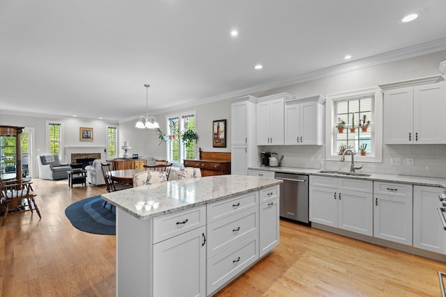 20 Webster Ln Unit 20, Middletown, CT 06457 - kitchen featuring stainless steel dishwasher, a sink, a brick fireplace, crown molding, and plenty of natural light