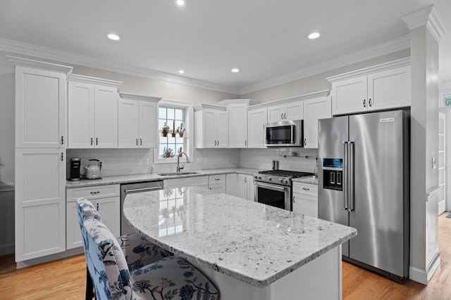 20 Webster Ln Unit 20, Middletown, CT 06457 - kitchen with premium appliances, a sink, light wood-style floors, white cabinets, and recessed lighting