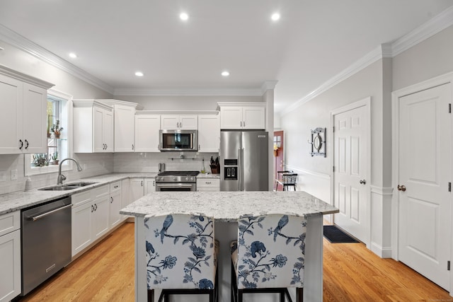 20 Webster Ln Unit 20, Middletown, CT 06457 - kitchen with appliances with stainless steel finishes, a sink, tasteful backsplash, light wood-style floors, and ornamental molding