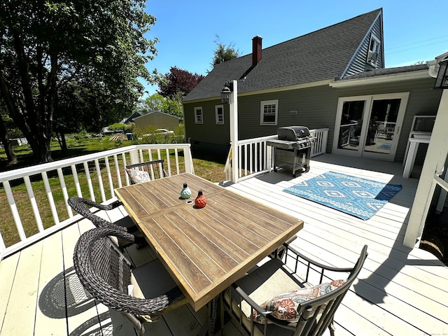 17 Aspen Ct, Norwich, CT 06360 - wooden deck featuring area for grilling, outdoor dining space, and a lawn