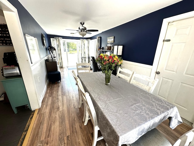 17 Aspen Ct, Norwich, CT 06360 - dining space featuring dark wood-style flooring, a ceiling fan, and wainscoting