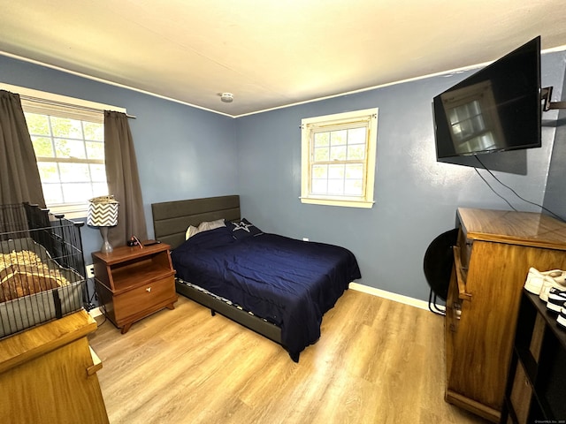 17 Aspen Ct, Norwich, CT 06360 - bedroom with light wood finished floors, multiple windows, and baseboards