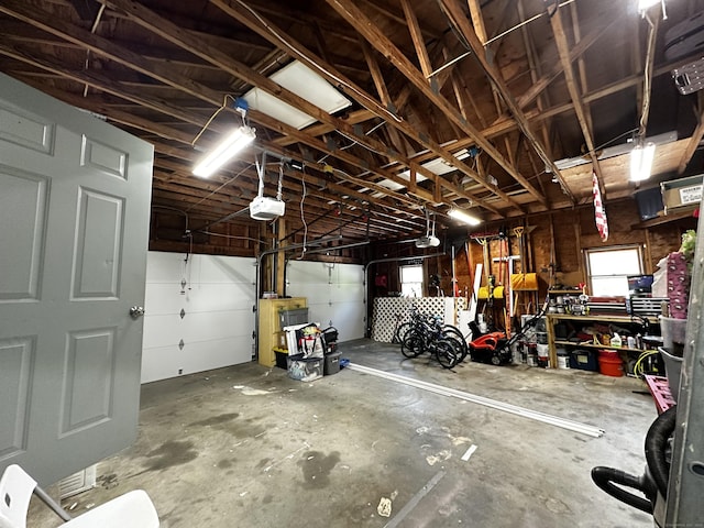17 Aspen Ct, Norwich, CT 06360 - garage featuring a garage door opener and a workshop area