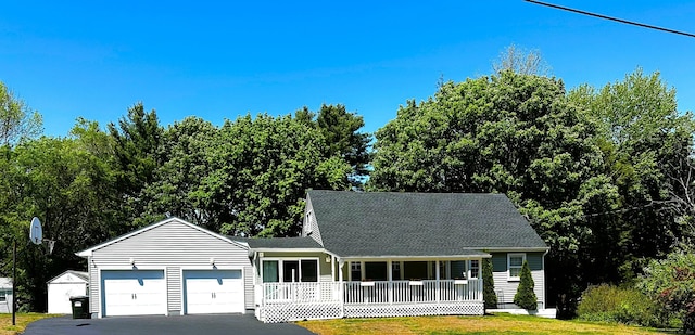 17 Aspen Ct, Norwich, CT 06360 - view of front facade featuring covered porch, an attached garage, driveway, a front yard, and roof with shingles
