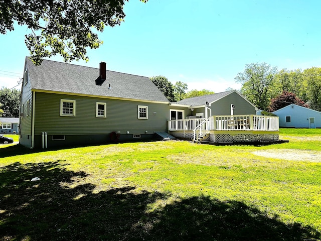 17 Aspen Ct, Norwich, CT 06360 - rear view of house featuring a wooden deck, a yard, a chimney, and roof with shingles