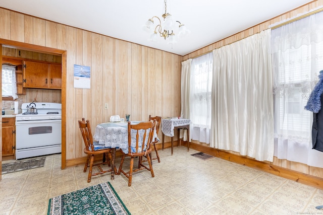 650 Broadview Ter, Hartford, CT 06106 - dining area featuring a chandelier, light floors, and wood walls