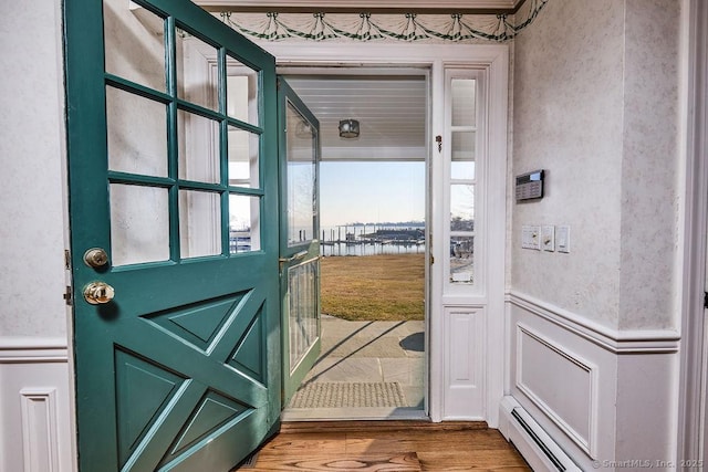14 Great Marsh Rd, Westport, CT 06880 - doorway with a decorative wall, wood finished floors, wainscoting, and a water view