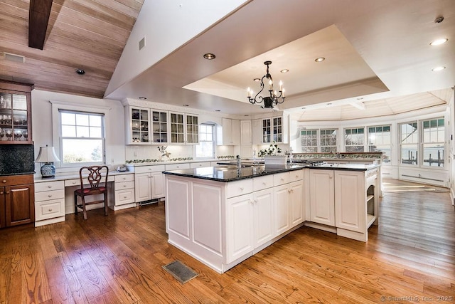 14 Great Marsh Rd, Westport, CT 06880 - kitchen with light wood-style floors, a chandelier, recessed lighting, a raised ceiling, and white cabinetry