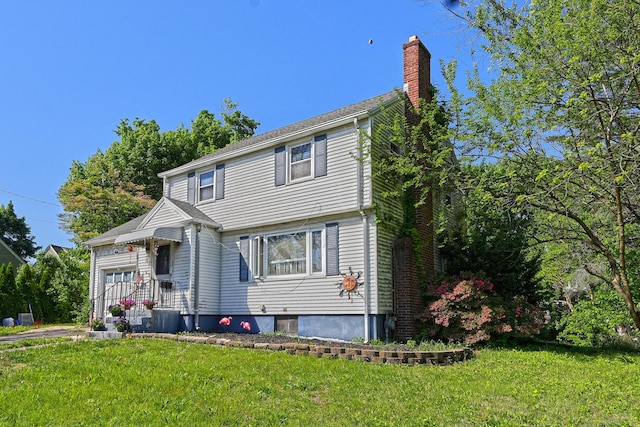 69 Homestead Ave, Hamden, CT 06514 - colonial house featuring a chimney, a front lawn, a garage, and cooling unit