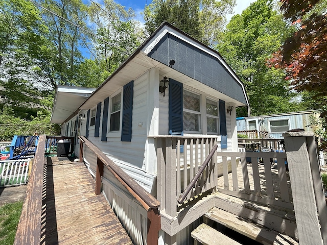 view of front facade with a wooden deck