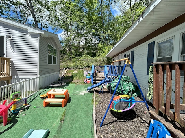 view of green lawn featuring a wooden deck