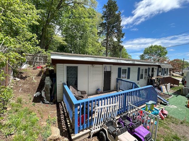 back of property featuring fence and a deck