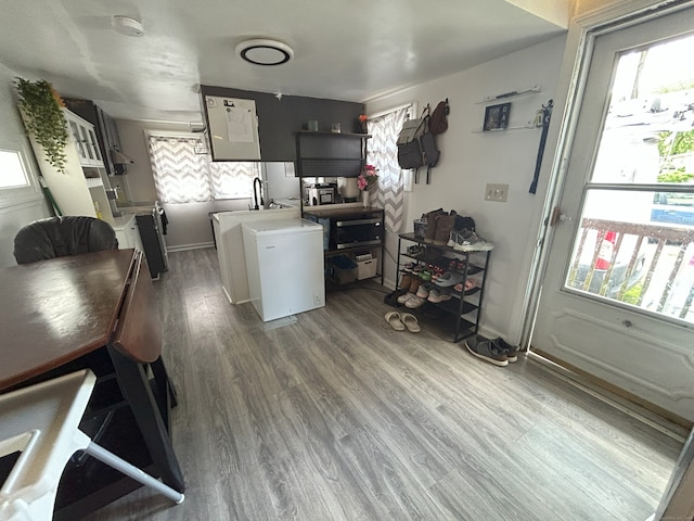 kitchen featuring fridge, wood finished floors, and light countertops