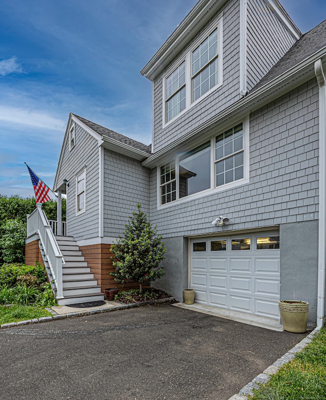 23 Hale St, Westport, CT 06880 - view of front of home featuring an attached garage, stairs, a shingled roof, and asphalt driveway