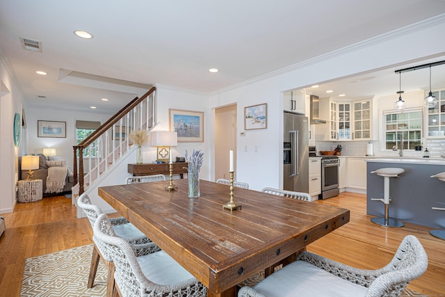 23 Hale St, Westport, CT 06880 - dining space featuring ornamental molding, light wood finished floors, recessed lighting, and stairs