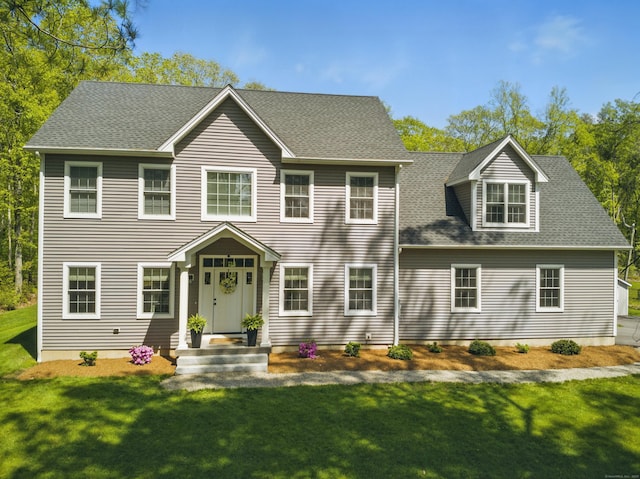 261 W St, Hebron, CT 06248 - back of property with a lawn and a shingled roof