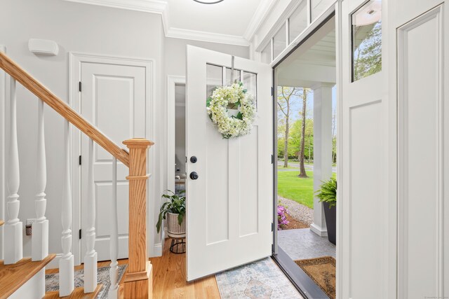 261 W St, Hebron, CT 06248 - entrance foyer featuring ornamental molding, stairs, and light wood-type flooring