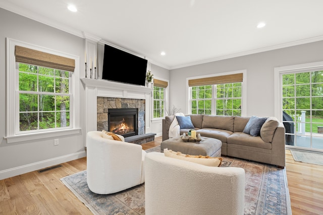 261 W St, Hebron, CT 06248 - living room featuring ornamental molding, healthy amount of natural light, a fireplace, light wood-style flooring, and recessed lighting