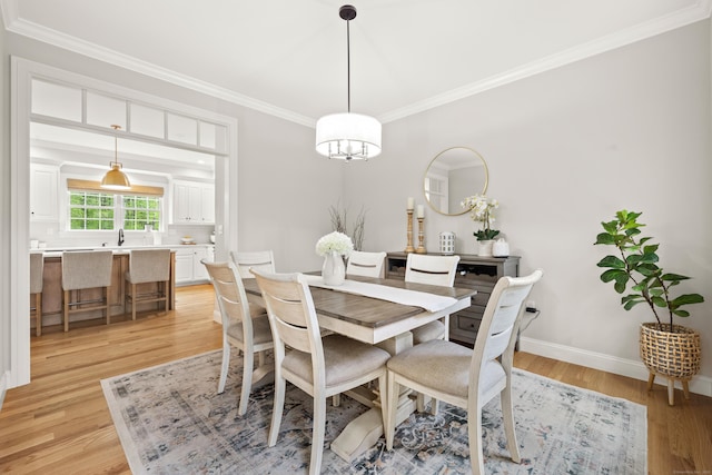 261 W St, Hebron, CT 06248 - dining room with crown molding, light wood-type flooring, baseboards, and a chandelier