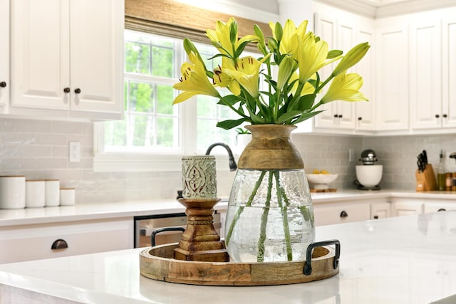 261 W St, Hebron, CT 06248 - kitchen view of white cabinetry, tasteful backsplash, and light countertops