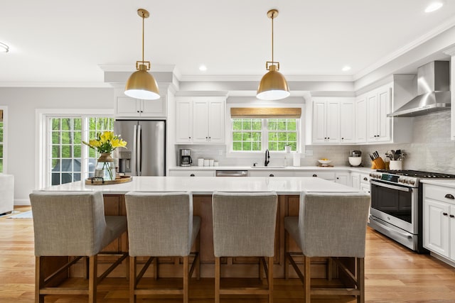 261 W St, Hebron, CT 06248 - kitchen featuring appliances with stainless steel finishes, wall chimney range hood, a sink, tasteful backsplash, and recessed lighting