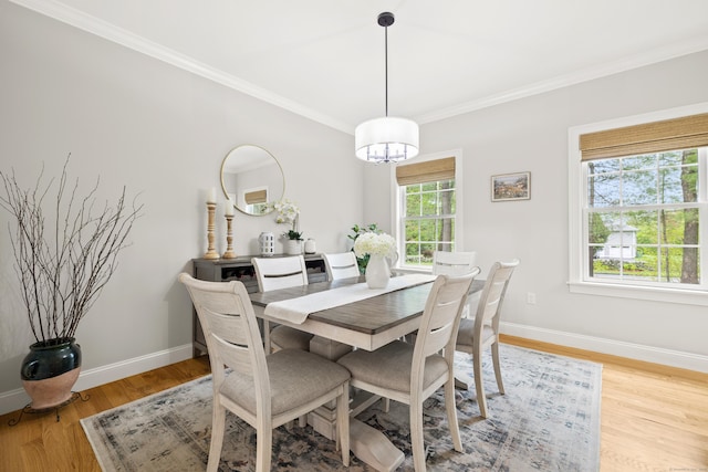 261 W St, Hebron, CT 06248 - dining space with crown molding, a chandelier, baseboards, and light wood finished floors