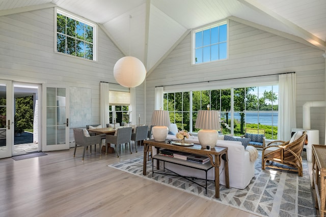 7 Hanna Ln, Essex, CT 06426 - living room featuring high vaulted ceiling, wood walls, wood finished floors, and a water view